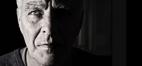 Elderly man's face half lit